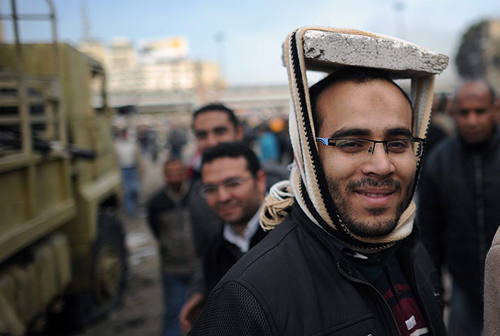 Un manifestante egiziano improvvisa un casco